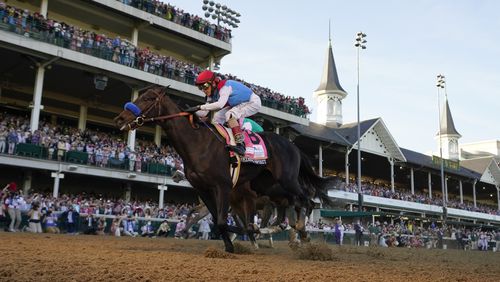 John Velazquez riding Medina Spirit crosses the finish line to win the 147th running of the Kentucky Derby at Churchill Downs, Saturday, May 1, 2021, in Louisville, Ky. (AP Photo/Jeff Roberson)