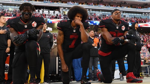 SANTA CLARA, CA - OCTOBER 06: (L-R) Eli Harold #58, Colin Kaepernick #7, and Eric Reid #35 of the San Francisco 49ers kneel in protest during the national anthem prior to their NFL game against the Arizona Cardinals at Levi's Stadium on October 6, 2016 in Santa Clara, California. (Photo by Thearon W. Henderson/Getty Images)