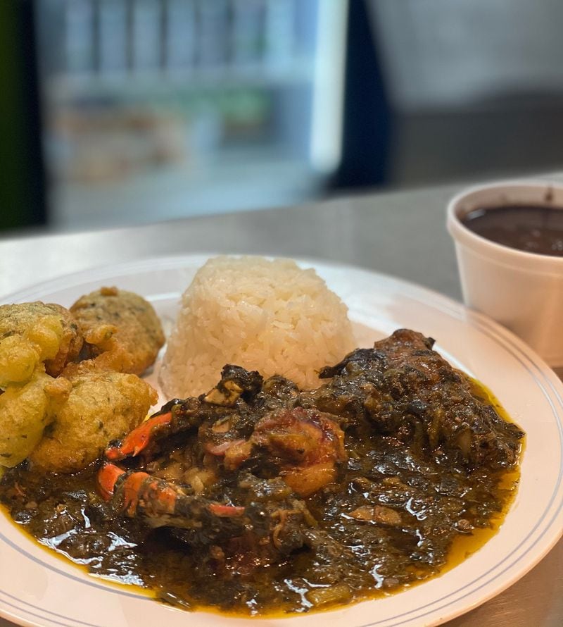 Jojo Fritay serves lalo, a Haitian stew of crab, pork and jute and spinach leaves, shown here with marinad fritters, white rice and black beans. Lalo means jute. 
Courtesy of Tercy Ugens Toussaint
