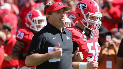 Georgia head coach Kirby Smart runs into Sanford Stadium with the team during the Bulldogs' G-Day spring football game Saturday, April 16, 2016 in Athens.