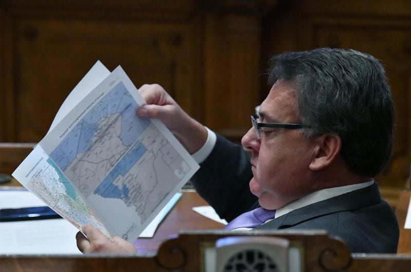 Sen. Steve Gooch (R-Dahlonega) looks at congressional maps in the Senate Chambers during a special session at the Georgia State Capitol in Atlanta on Nov. 19, 2021. Georgia lawmakers are scheduled to meet for a legislative special session later this month to again redraw political district maps. (Hyosub Shin/hyosub.shin@ajc.com)