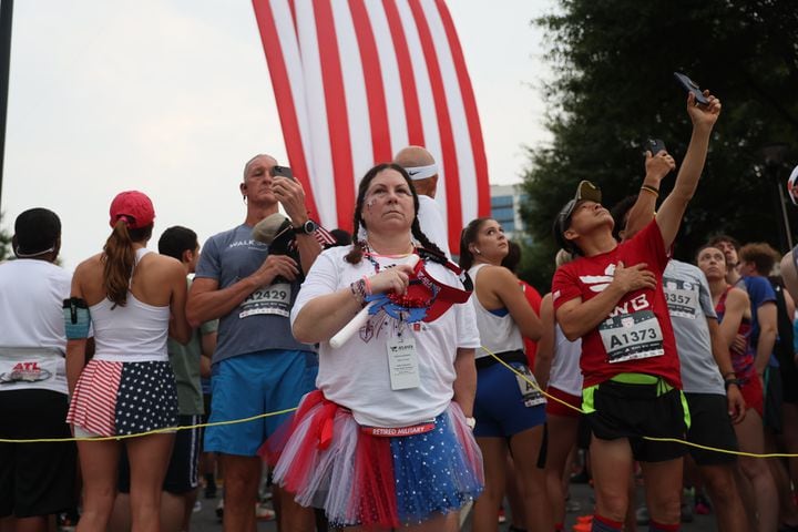 Marylyn Key stands for the National Anthem at the start of the 54th running of the Atlanta Journal-Constitution Peachtree Road Race in Atlanta on Tuesday, July 4, 2023.   (Arvin Temkar / Arvin.Temkar@ajc.com)