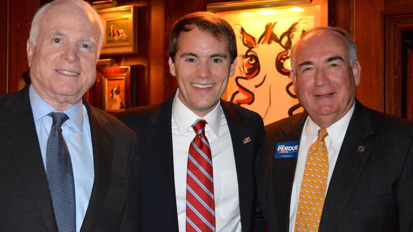 John McCain, Evan Karanovich and Alec Poitevint pose at a campaign event for Georgia U.S. Sen. David Perdue.