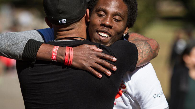 LaMar Yarborough greets a friend while volunteering at the 25th Annual AIDS Walk Atlanta & 5K Run in Piedmont Park Sunday, October 18, 2015.