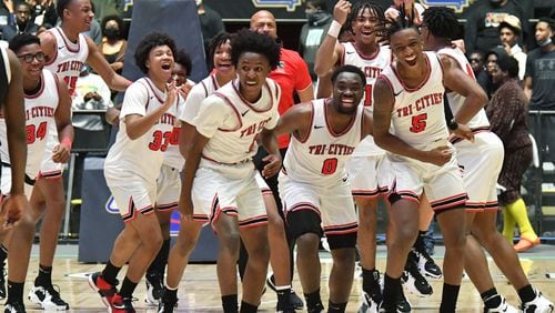 March 10, 2022 Macon - Tri-Cities players celebrate their victory over Eagle's Landing during the 2022 GHSA State Basketball Class AAAAA Boys Championship game at the Macon Centreplex in Macon on Thursday, March 10, 2022. Tri-Cities won 67-59 over Eagle's Landing. (Hyosub Shin / Hyosub.Shin@ajc.com)