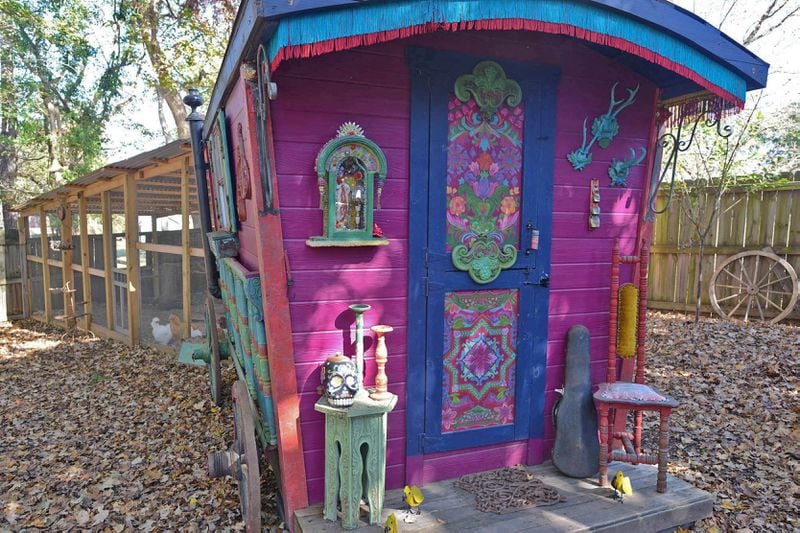The colorful chicken coop uses old wagon wheels and spindles from Europe, along with handpainted details and fringe.