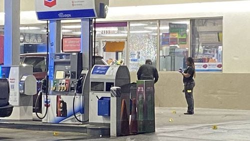 Two men were arrested after a bystander was shot at a Chevron in north Atlanta.