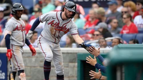 Braves shortstop Dansby Swanson is greeted at the dugout after he scored on a wild pitch by Washington Nationals relief pitcher Gabe Klobosits during the fifth inning  Sunday, Aug. 15, 2021, in Washington. Swanson hit three homers in the series sweep in Washington. (Nick Wass/AP)
