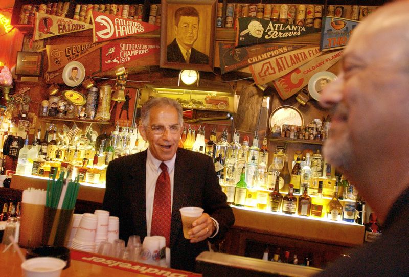 040812 - ATLANTA, GA -- Robert Maloof (cq), brother of Manuel Maloof, behind the bar at Manuel's, telling stories about him and his brother during a wake at Manuel's, for former DeKalb CEO, Manuel Maloof. Also pictured far right is Harry Kuniansky (cq). (JOEY IVANSCO/AJC staff).