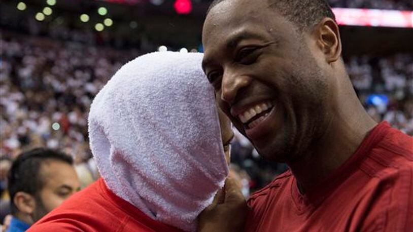 Miami Heat's Dwyane Wade, right, congratulates Toronto Raptors' Kyle Lowry following Game 7 of the NBA basketball Eastern Conference semifinals in Toronto, Sunday, May 15, 2016. The Raptors won 116-89. (Frank Gunn/The Canadian Press via AP) MANDATORY CREDIT