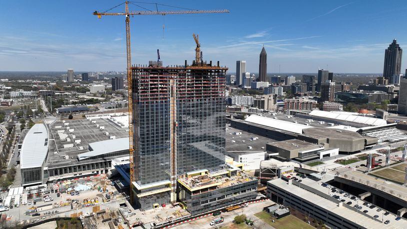 Aerial photograph shows construction site of Signia by Hilton Atlanta at Georgia World Congress Center, as construction crew prepare for topping out ceremony, Thursday, March 23, 2023, in Atlanta. Plans are in motion for GWCCA’s new headquarter hotel Signia by Hilton Atlanta. Featuring close to 1,000 rooms, this premier full-service hotel will sit on the northwest corner of the campus, adjacent to Building C of Georgia World Congress Center. (Hyosub Shin / Hyosub.Shin@ajc.com)
