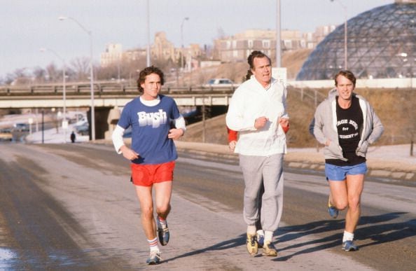 1980: American politician (and future US Vice President, and later President) George HW Bush (center) jogs
