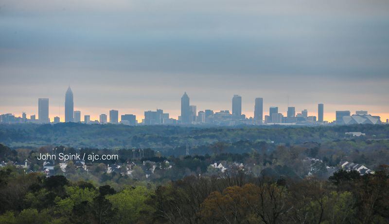 A layer of clouds hangs low over downtown Atlanta and across Cobb County on Tuesday morning. JOHN SPINK / JSPINK@AJC.COM
