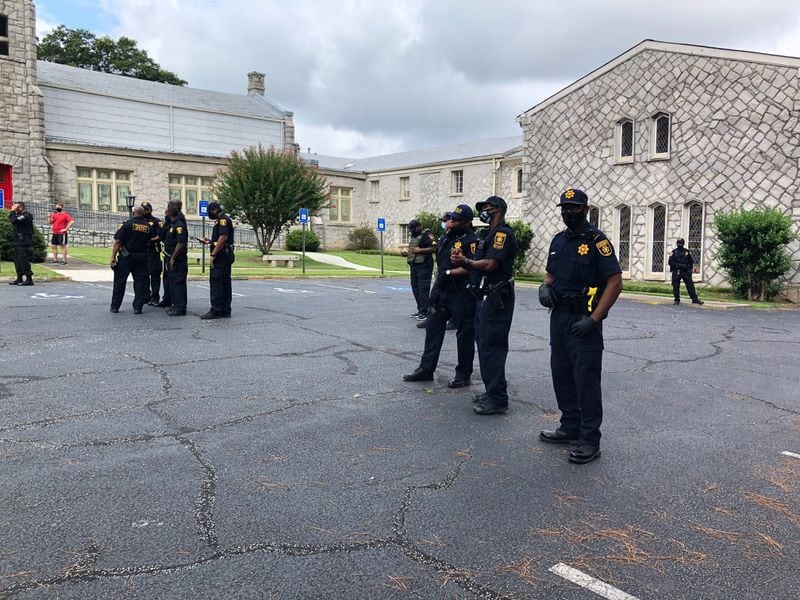 Saturday, Aug. 15, 2020, Stone Mountain -- Dekalb Sheriff’s deputies watch the Stone Mountain protest from a distance.