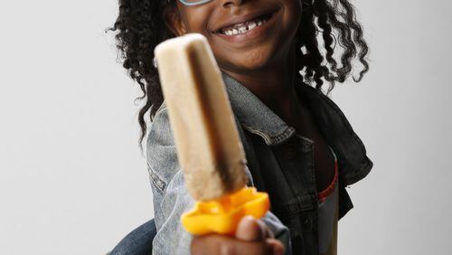Ellington Young, 7, poses for a portrait with a vanilla ice cream and root beer popsicle in the studio in Dallas on Friday, June 7, 2018. (Vernon Bryant/The Dallas Morning News/TNS)