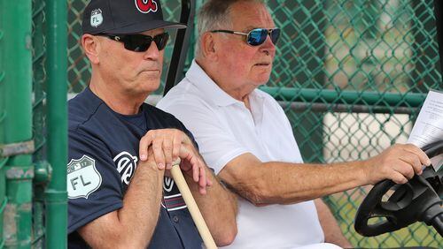 Braves manager Brian Snitker, watched a spring-training workout seated next to his mentor, legendary former Braves manager Bobby Cox. (Curtis Compton/AJC file photo)