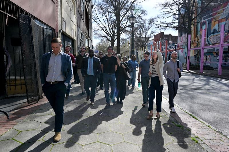 Jon Birdsong (front left) and April Stammel (front right) lead a recent walking tour of South Downtown.
