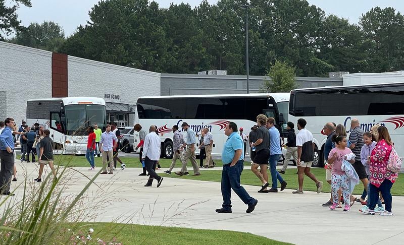 Georgia football players disembark from four buses to join the congregation of Athens Church for Sunday morning services on Aug. 15, 2021 in Athens, GA. (Photo by Chip Towers/ctowers@ajc.com)