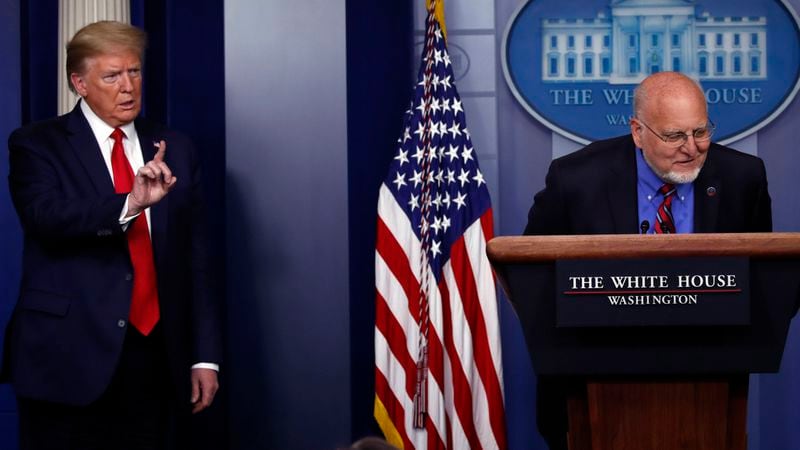 President Donald Trump listens as Dr. Robert Redfield, director of the Centers for Disease Control and Prevention, speaks about the coronavirus in the James Brady Press Briefing Room of the White House, Wednesday, April 22, 2020, in Washington. (AP Photo/Alex Brandon)