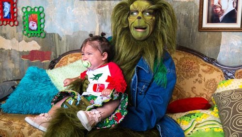 Pets can take pictures with holiday characters, including the Grinch, at the Gwinnett County Animal Shelter this weekend. The Grinch in this photo is “in residence” at Ponce City Market on weekends leading up to Christmas.