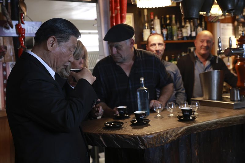 Chinese President Xi Jinping drinks coffee in a restaurant, Tuesday, May 7, 2024 at the Tourmalet pass, in the Pyrenees mountains. French president is hosting China's leader at a remote mountain pass in the Pyrenees for private meetings, after a high-stakes state visit in Paris dominated by trade disputes and Russia's war in Ukraine. French President Emmanuel Macron made a point of inviting Chinese President Xi Jinping to the Tourmalet Pass near the Spanish border, where Macron spent time as a child visiting his grandmother. (AP Photo/Aurelien Morissard, Pool)