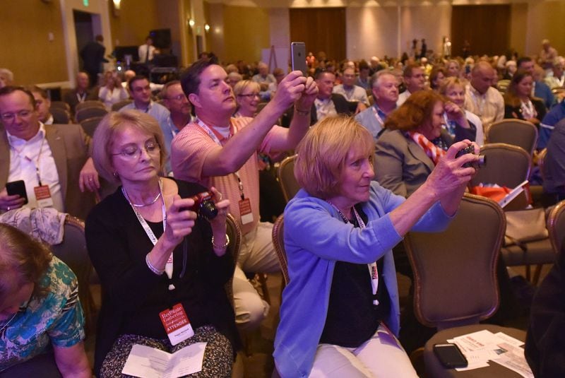 Attendees take pictures as former Arkansas Gov. Mike Huckabee speaks during the RedState Gathering at the Intercontinental Buckhead Hotel in August 2015.