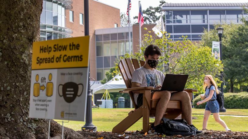 Kennesaw State University freshman Kyle Johnson wears a mask as he works on his computer during the first day of classes at Kennesaw State University's main campus in Kennesaw, Monday, August 17, 2020. Kennesaw State's enrollment increased by about 9% this fall. The university has more than 41,000 students this year. Only Georgia State University has a larger enrollment, with about 54,000 students. (ALYSSA POINTER / ALYSSA.POINTER@AJC.COM)