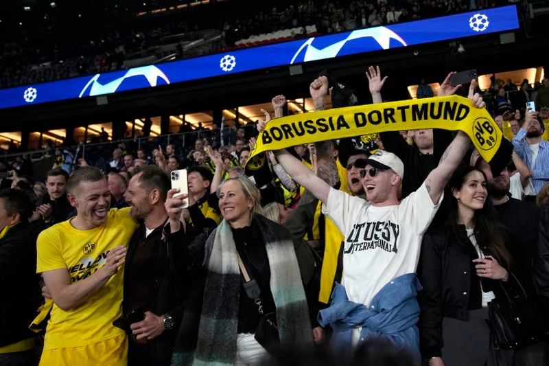 Dortmund's Julian Ryerson celebrates with fans after the Champions League semifinal second leg soccer match between Paris Saint-Germain and Borussia Dortmund at the Parc des Princes stadium in Paris, France, Tuesday, May 7, 2024. (AP Photo/Christophe Ena)