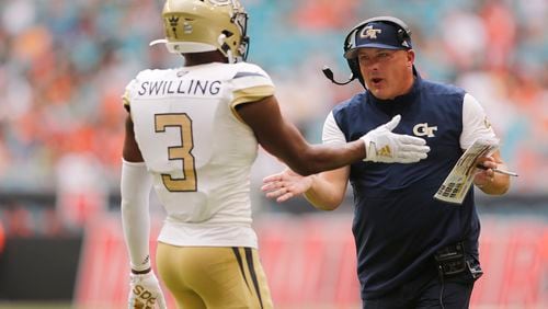 Tre Swilling of the Georgia Tech Yellow Jackets celebrates with coach Geoff Collins against the Miami Hurricanes during the first half at Hard Rock Stadium on October 19, 2019 in Miami, Florida. (Photo by Michael Reaves/Getty Images)