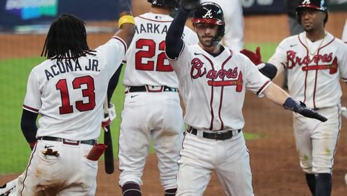 Braves celebrate taking 7-4 lead over Marlins in Game 1 of the National League Division Series Tuesday, Oct. 6, 2020, at Minute Maid Park in Houston. (Curtis Compton / Curtis.Compton@ajc.com)