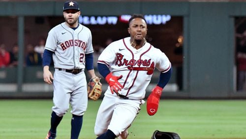 Atlanta Braves second baseman Ozzie Albies runs to third base on a single by third baseman Austin Riley (not pictured) as Houston Astros second baseman Jose Altuve is shown during the first inning in Game 5 of the World Series at Truist Park, Sunday, Oct. 31, 2021, in Atlanta. (Hyosub Shin/The Atlanta Journal-Constitution/TNS)