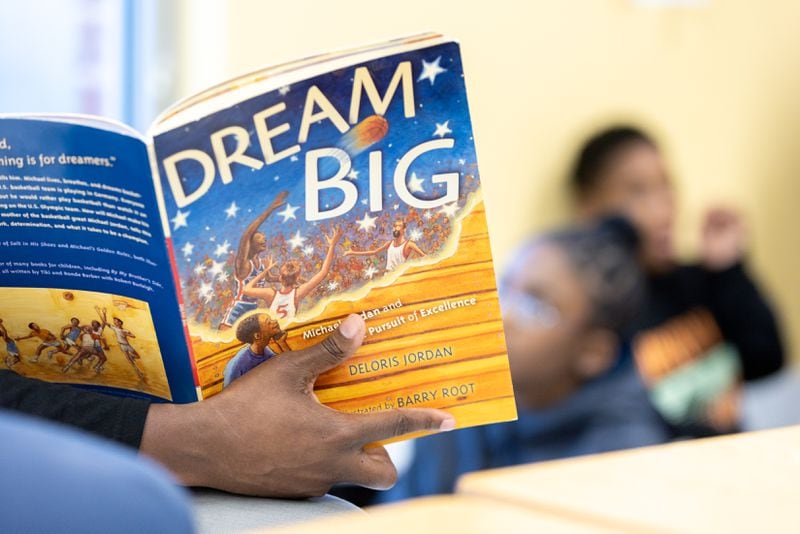 Jermaine White, a member of Alpha Phi Alpha Fraternity's Omicron Phi Lambda chapter based in East Point, reads to fifth graders at Asa G. Hilliard Elementary School in East Point on Wednesday, March 27, 2024. (Arvin Temkar / arvin.temkar@ajc.com)