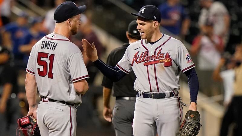 Freddie Freeman (right) congratulates reliever Will Smith (51) after Smith got out of a bases-loaded jam in the bottom of the seventh inning of the second baseball game of a doubleheader against the New York Mets, Monday, June 21, 2021, in New York.