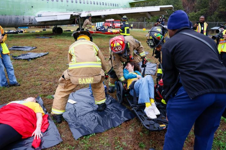 Firefighters help to care for a fake victim in a wheelchair as Hartsfield-Jackson International Airport held a full-scale disaster drill with Atlanta Firefighters, law enforcement, rescue personnel, and nearly 70 volunteers who participated in a triennial exercise known as “Big Bird” on Wednesday, March 6, 2024.
Miguel Martinez /miguel.martinezjimenez@ajc.com