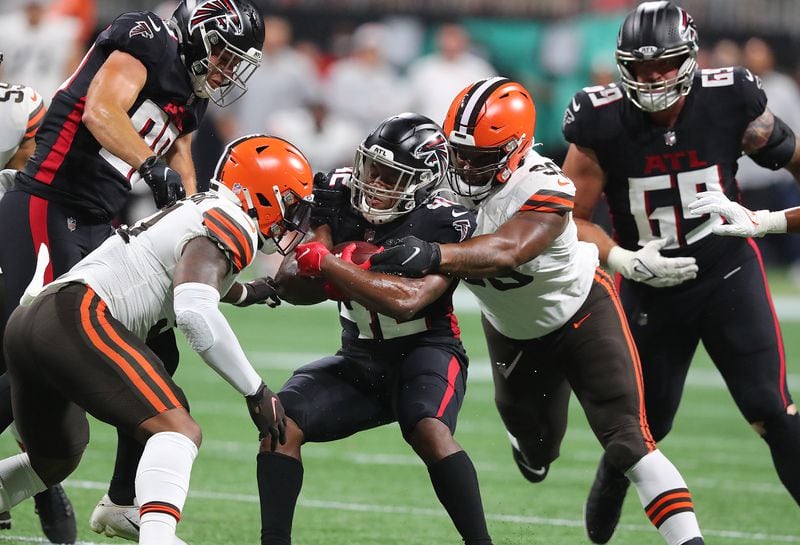Falcons running back Caleb Huntley is sandwiched by Cleveland Browns defenders for short yardage during the first half Sunday, Aug. 29, 2021, at Mercedes-Benz Stadium in Atlanta. (Curtis Compton / Curtis.Compton@ajc.com)