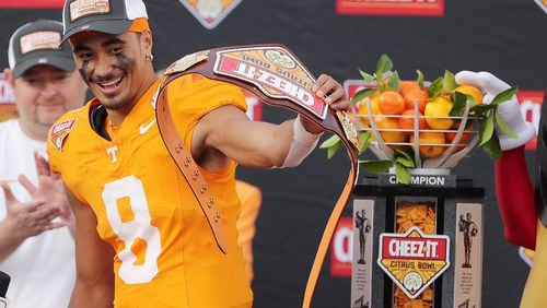 Tennessee quarterback Nico Iamaleava celebrates with the championship trophy after winning the Cheez-It Citrus Bowl college football game of Tennessee versus Iowa at Camping World Stadium in Orlando on Monday, Jan. 1, 2024. Tennessee won the game 35-0. (Stephen M. Dowell/Orlando Sentinel/TNS)