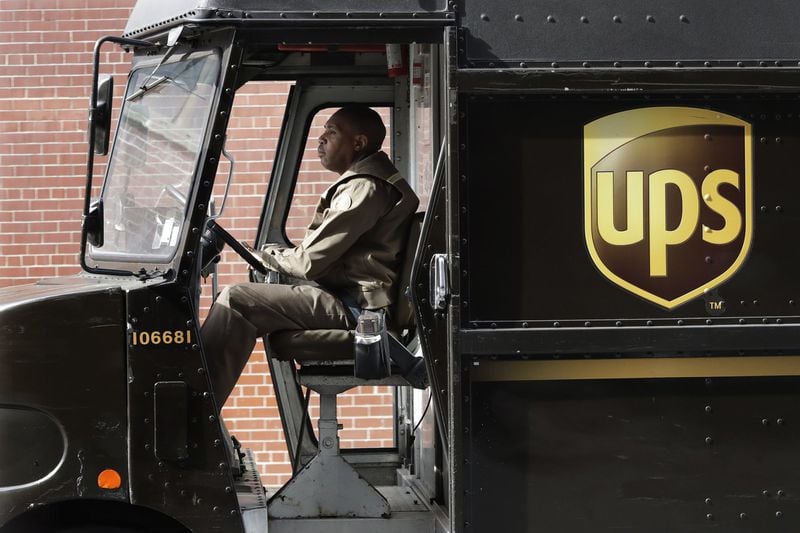 A UPS driver takes his truck on a delivery route, in New York. AP Photo/Mark Lennihan)