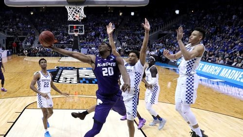 Against Kentucky, Kansas State's Xavier Sneed demonstrates that one's reach should always exceed one's grasp. (Ronald Martinez/Getty Images)