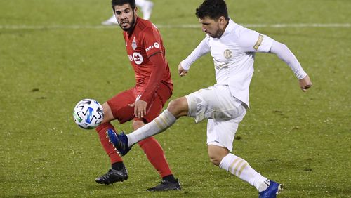 Atlanta United's Eric Remedi kicks the ball as Toronto FC's Alejandro Pozuelo defends during the second half Sunday, Oct. 18, 2020, in East Hartford, Conn. (Jessica Hill/AP)