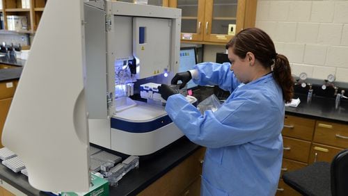 Erin Norris GBI forensic scientist is pictured using a genetic analyzer to processes a rape kit at the GBI Crime lab in Decatur in 2015. BRANT SANDERLIN/BSANDERLIN@AJC.COM