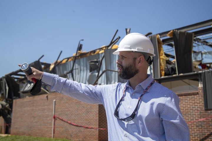 Newnan High School principal Chase Puckett surveys the damage at the school from an EF4 tornado. (Alyssa Pointer / Alyssa.Pointer@ajc.com)