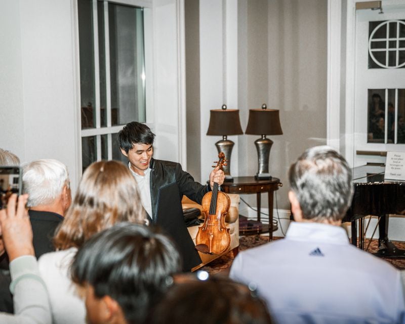 Kevin Zhu shows off his 300-year-old Stradivarius violin.
