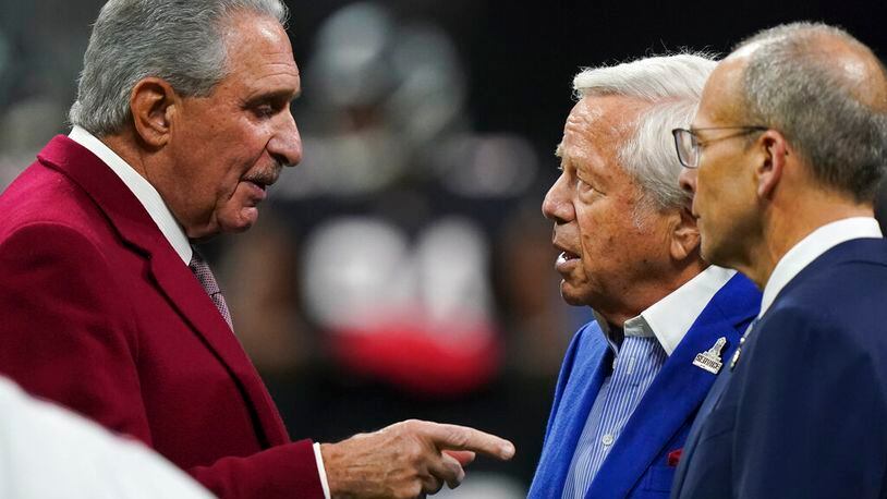 Atlanta Falcons owner Arthur Blank, left, speaks with New England Patriots owner Robert Kraft, second from right, before a game in Atlanta. Blank, a member of the NFL’s Diversity, Equity and Inclusion committee, believes the league has dropped the ball by not hiring more Black head coaches. (AP Photo/Brynn Anderson)