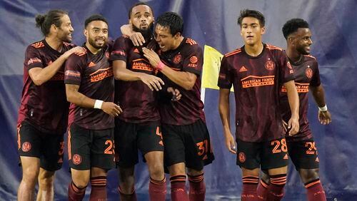 Atlanta United defender Anton Walkes (4) is congratulated after scoring a goal against Nashville SC during the first half of an MLS soccer match Thursday, July 8, 2021, in Nashville, Tenn. (AP Photo/Mark Humphrey)