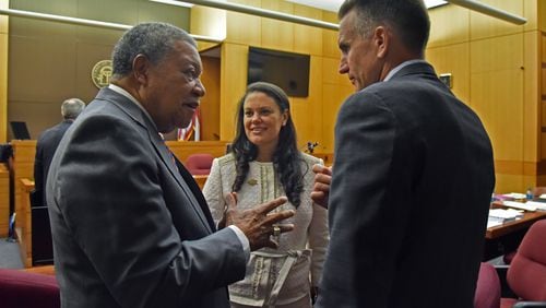 Robb Pitts (left), chairman of Fulton County Board of Commissioners, celebrates with Meria Carstarphen, superintendent of Atlanta Public Schools, and Jeff Rose (right), superintendent of Fulton County Schools after Judge Alan Harvey ruled to allow Fulton County to collect tax money  on Tuesday, August 14, 2018. HYOSUB SHIN / HSHIN@AJC.COM