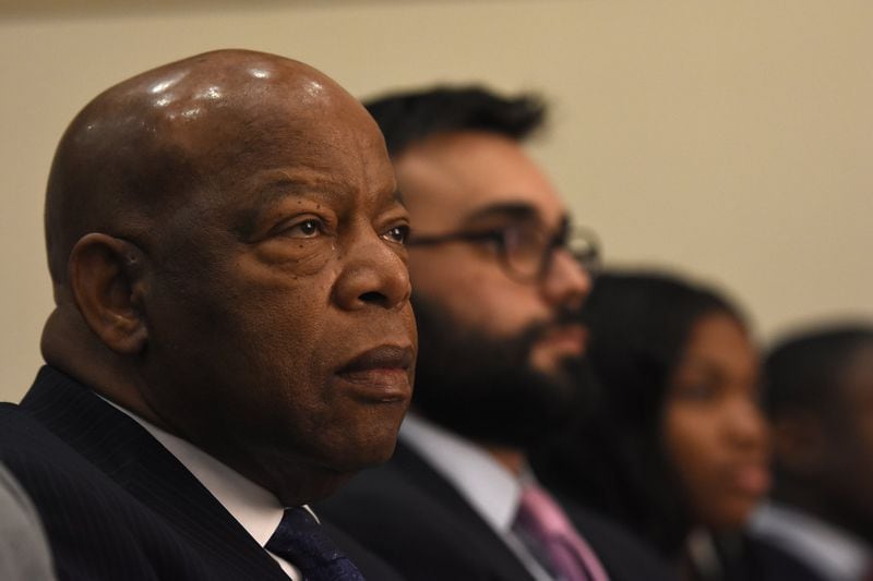 The late Congressman John Lewis, left, is pictured listening to speakers with author Andrew Aydin, center, during the Secondary English/Language Arts Fall Symposium at Martin Luther King, Jr. Middle School in Atlanta, on Monday, October 24, 2016. Lewis and Aydin collaborated on a graphic novel about Lewis’ life. (David Barnes/The Atlanta Journal-Constitution)