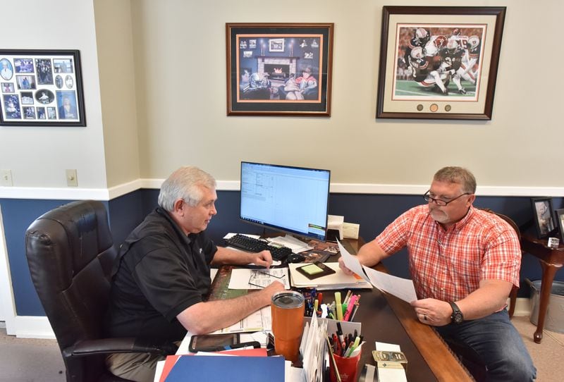 April 9, 2019 Blakely - Hank Jester (left), owner/agent, helps his customer Steve Jackson, who is a farmer, in Jester's office at Cornerstone Insurance Group in Blakely on Tuesday, April 9, 2019. Mr. Hank Jester is a banker, insurer and a farmer is Blakely, Ga. Congress' delay in finalizing an aid package for Hurricane Michael victims has had a real impact on the ground in Georgia. HYOSUB SHIN / HSHIN@AJC.COM