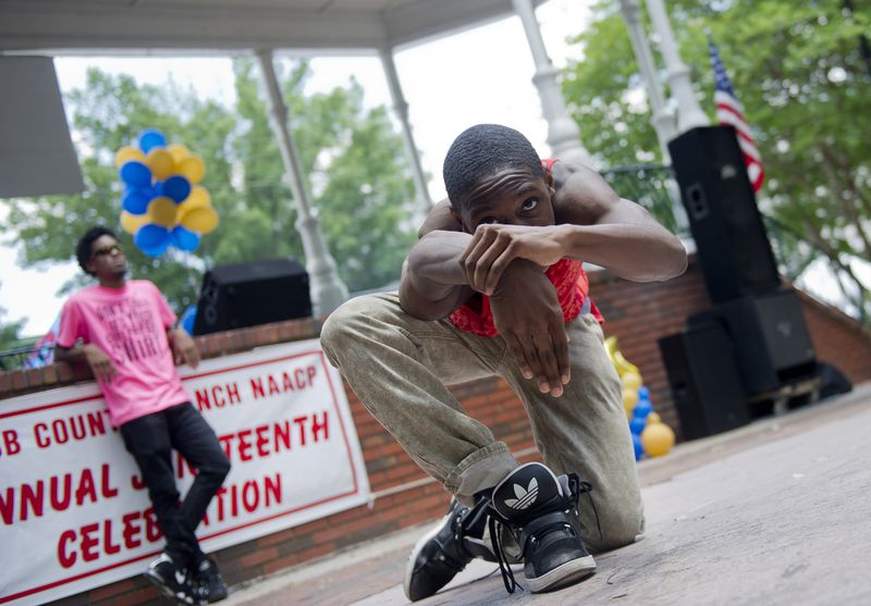 Matthew Gibbs (center), half of the performance duo Kinetix, performs with James D. Love during a Juneteenth Celebration in Marietta Square. (Jonathan Phillips)