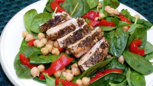 Tender chicken coated with French herbes de Provence and served over a bed of baby spinach salad is a simple and fast dish. (Linda Gassenheimer/TNS)