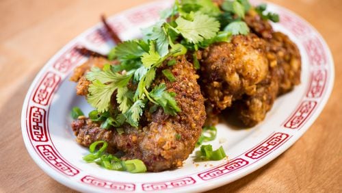 Double Dragon Chongqing Chicken Wings with sichuan peppercorns, dried chilies, scallions, cilantro. / Photo credit- Mia Yakel.